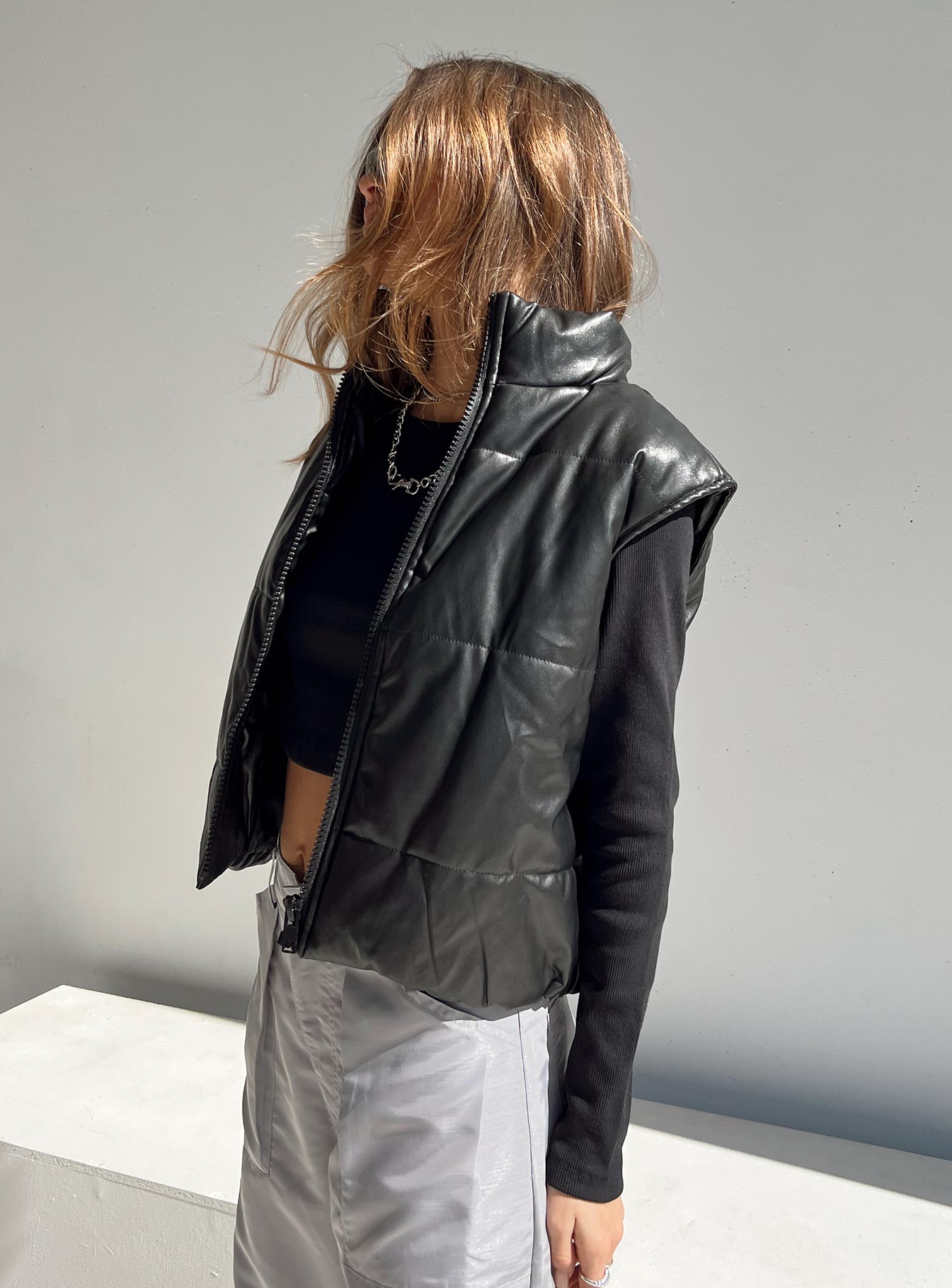 Puffer vest Main: 65% PU 35% polyester Lining: 100% polyester Faux leather material High neck Zip front fastening Elasticated waist Non stretch Fully lined