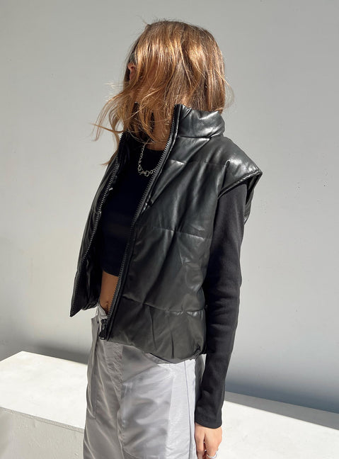 Puffer vest Main: 65% PU 35% polyester Lining: 100% polyester Faux leather material High neck Zip front fastening Elasticated waist Non stretch Fully lined