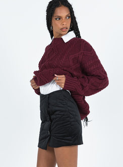 Black mini skirt Quilted material High rise Invisible zip fastening at back Button detail at front