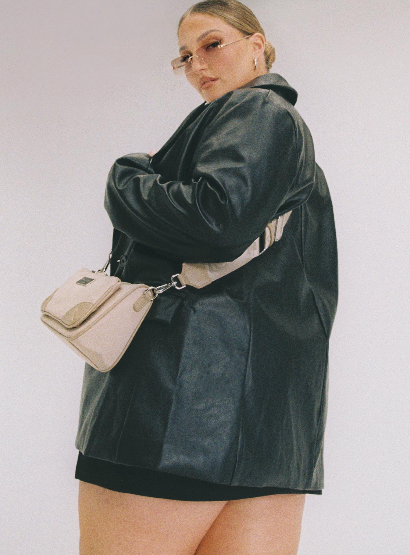 Black blazer relaxed fit Faux leather material Lapel collar Button front fastening Twin front pockets