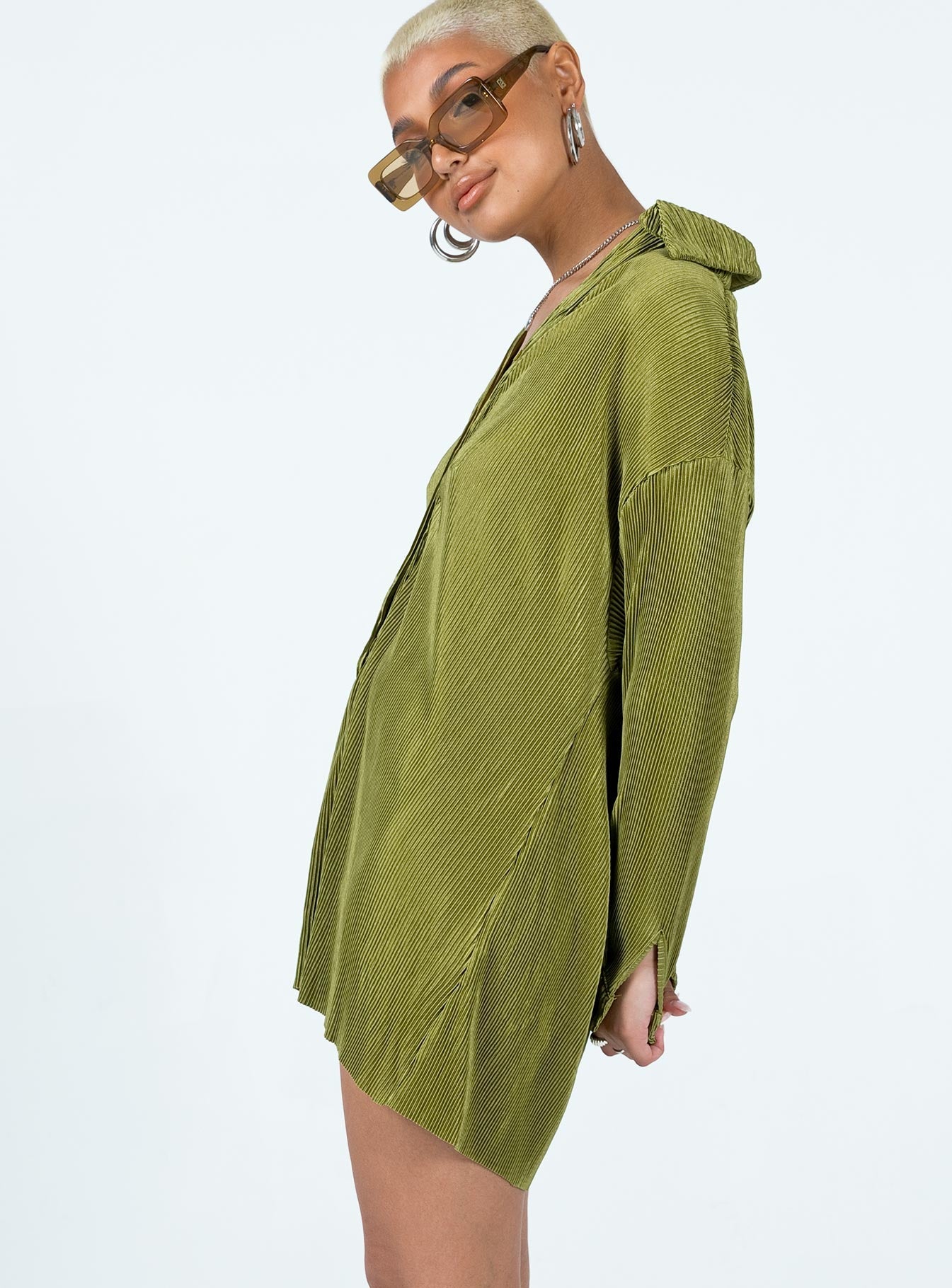Green romper Silky material  Pleated design  Classic collar  Button front fastening  Drop shoulder  Button fastening at cuffs Raw cut hem 
