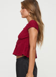 v neck top Cap sleeve, textured material, ruffle detail, tie detail at bust, elasticated back