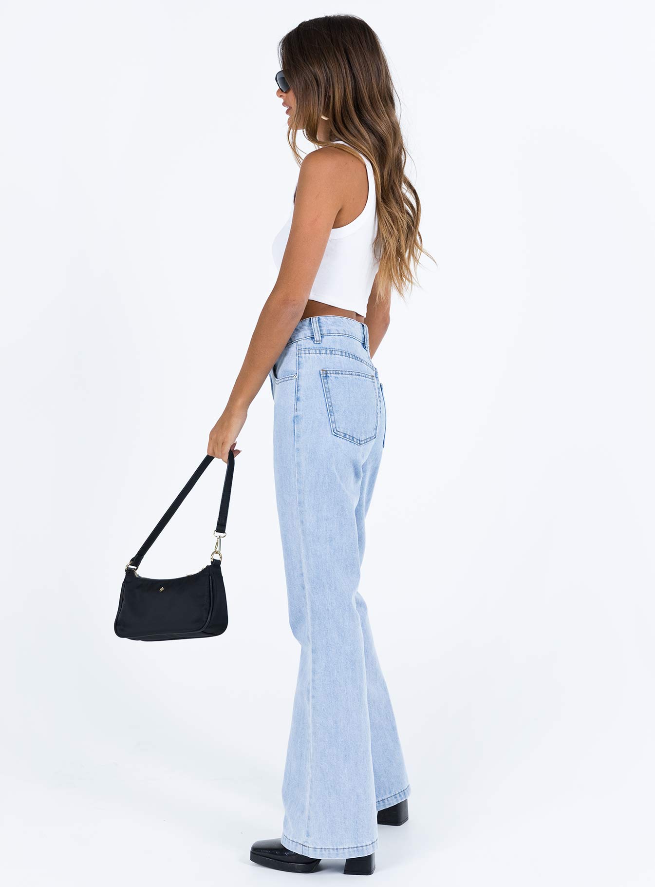 Jeans Cotton Mid wash denim High rise Belt looped waist Classic five pocket design Zip and button fastening Flared leg