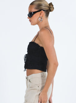 Crop top Lace material  Ruffle neckline  Adjustable shoulder straps  Inner silicone strip at bust  Lace up fastening at front Non stretch Fully lined 