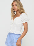 White Puff sleeve, v-neckline, pleats at front, button fastening down front, lace trim, fril hem