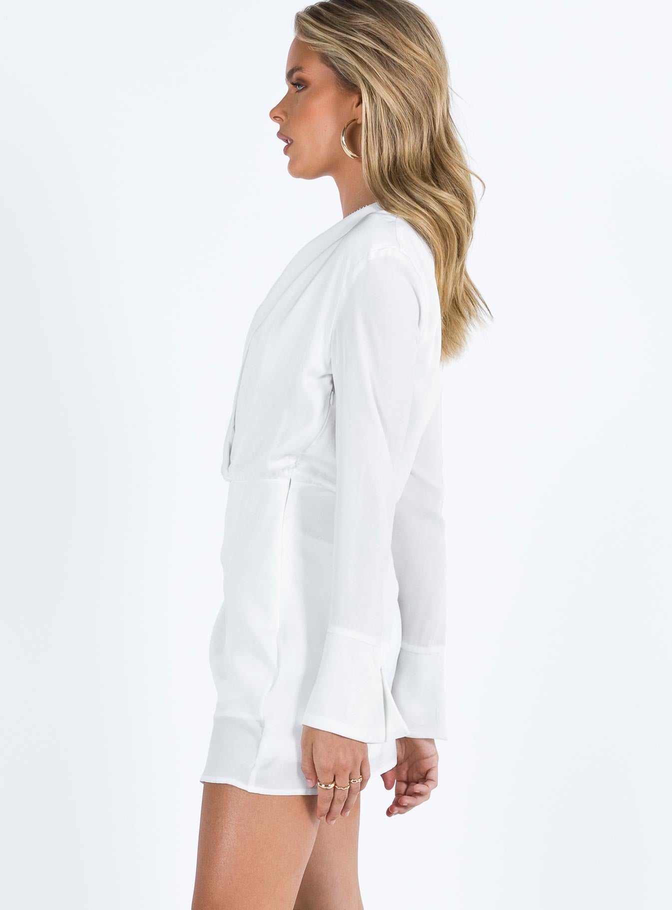 White long sleeve mini dress Silky material Lapel collar Plunging neckline Invisible zip fastening at side Slight ruching at waist Non stretch Partially lined