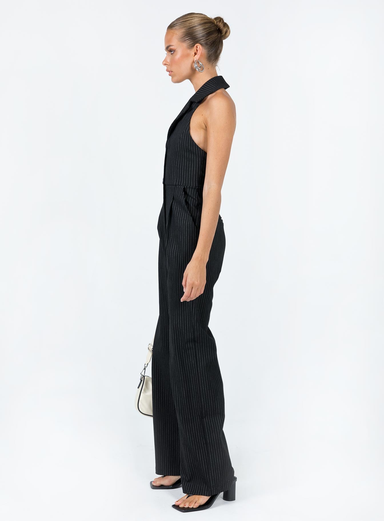 Jumpsuit  Princess Polly exclusive Main: 100% brocade cotton  Lining: 95% polyester 5% elastane Pinstripe print  Halter neck Lapel collar  Plunging neckline  Button & zip front fastening  Exposed back  Twin hip pockets  Faux back pockets  Wide leg 