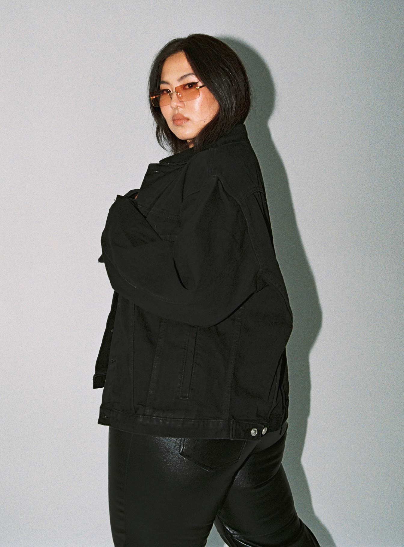 Oversized black denim jacket Button front fastening Four pocket design Single-button cuff Silver buttons