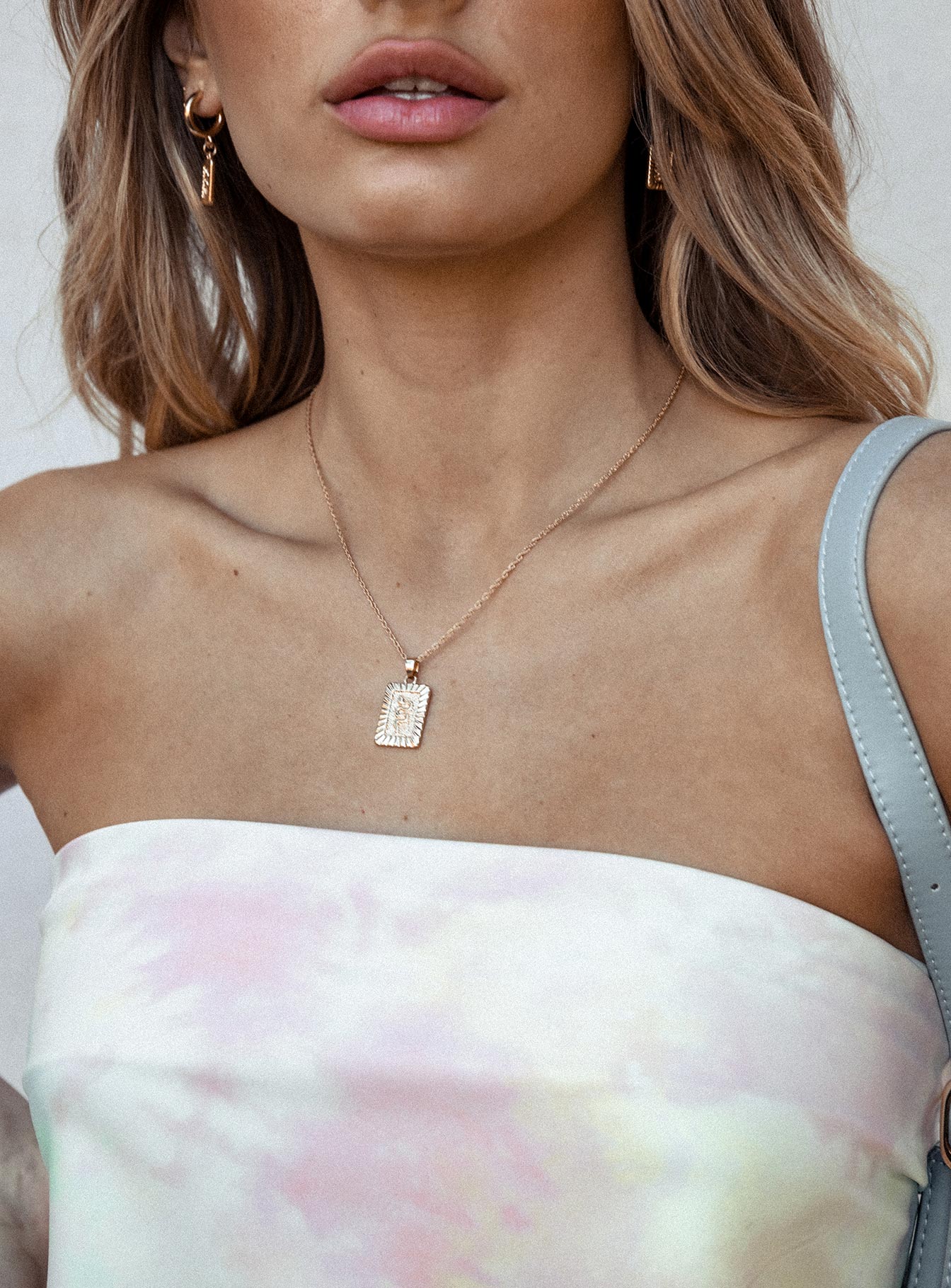 Necklace Drop charm with snake detail Dainty rope chain Gold toned hardware Lobster clasp fastening