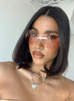 Sunglasses Frameless design  Pink tinted lenses Adjustable silicone nose pads 