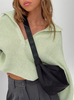 Black crossbody bag Nylon material Adjustable strap Zip fastening Internal slip pocket Silver toned hardware