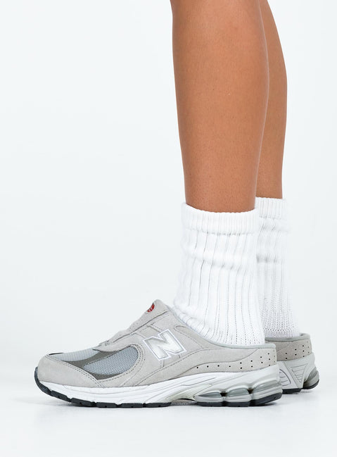 Faux suede sneakers, slip-on style Padded footbed, mesh netting detail, treaded sole