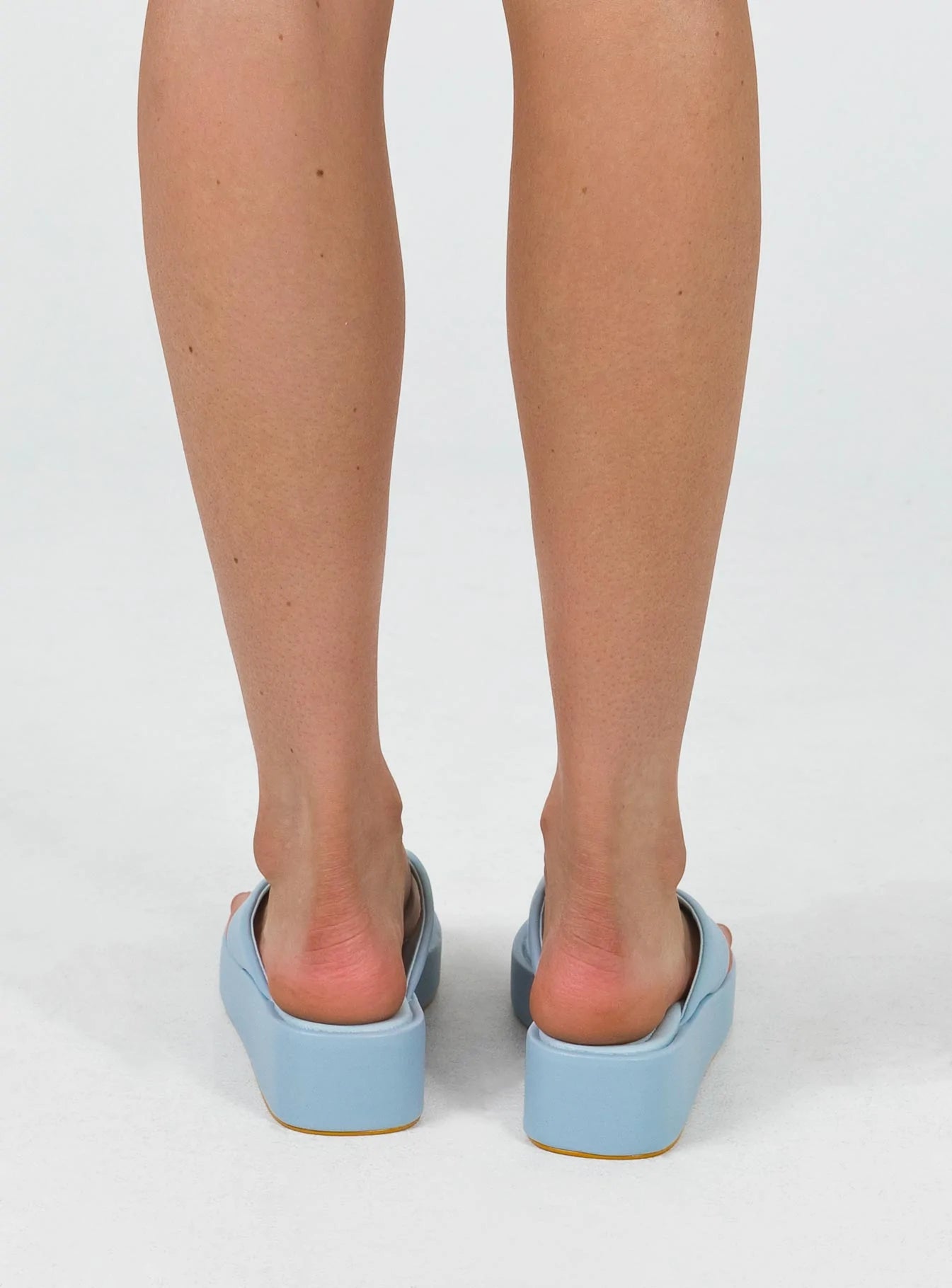 Platform sandals Platform base Thin flip-flop style upper Padded footbed Rounded toe