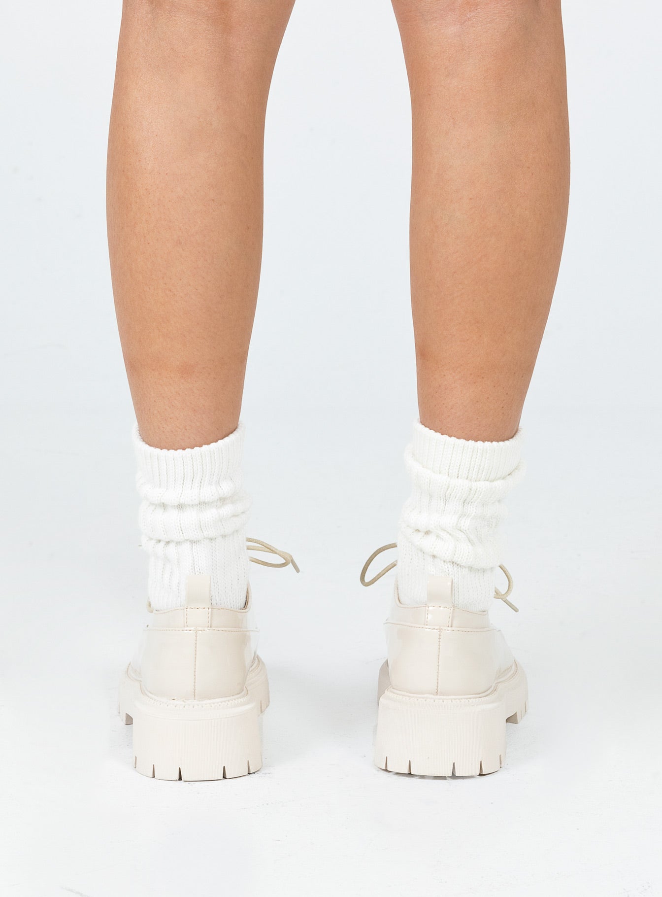 Shoes Faux leather material  High shine  Lace up  Rounded toe  Pull tab at heel  Platform base  Treaded sole 