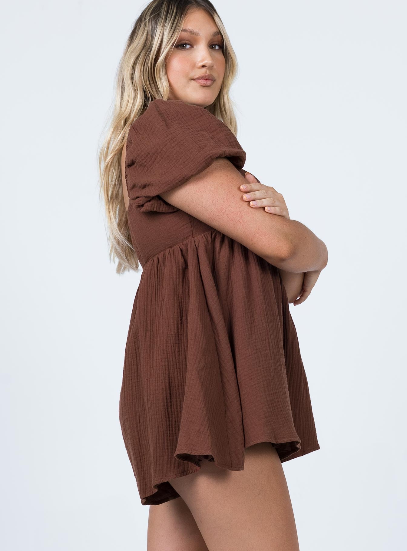 Romper Muslin material Square neckline  Elasticated puff sleeves Shirred back panel Invisible zip fastening at back  Relaxed leg 