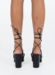 Black heels Faux leather material Strappy upper Shaved block heel Square toe Ankle wrap fastening