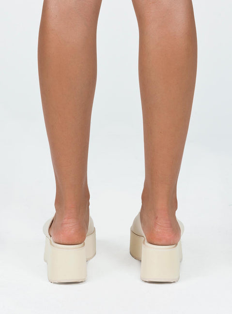 Sandals Single wide upper  Platform base  Rounded toe 