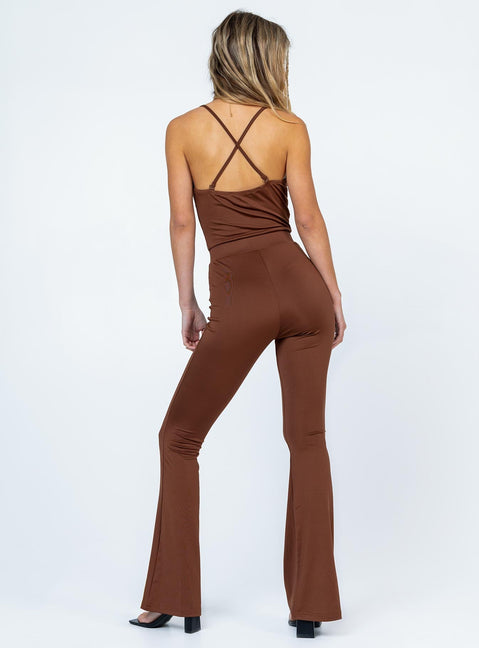 Jumpsuit  Slim fitting  Princess Polly Exclusive 92% recycled fibers 8% elastane  Thin shoulder straps  Straps can be worn crossed over or straight back  Elasticated waistband  Flared leg 