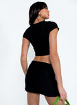 Black matching set Detailed material  Cropped tee Low-rise mini skirt  Elasticated waistband  Side slit 