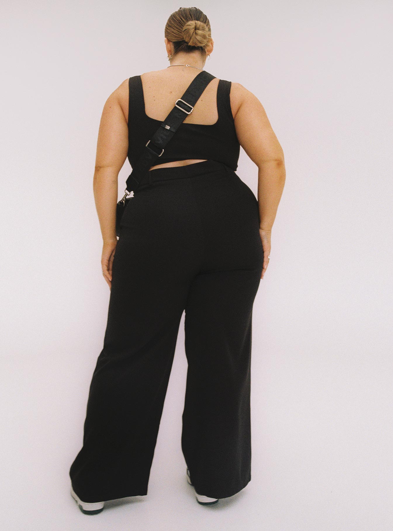 Black matching set Crop top Fixed straps Invisible zip fasting at side High waisted pants Wide relaxed leg Belt loops at waist Zip & button fastening