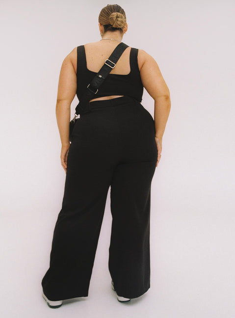 Black matching set Crop top Fixed straps Invisible zip fasting at side High waisted pants Wide relaxed leg Belt loops at waist Zip & button fastening