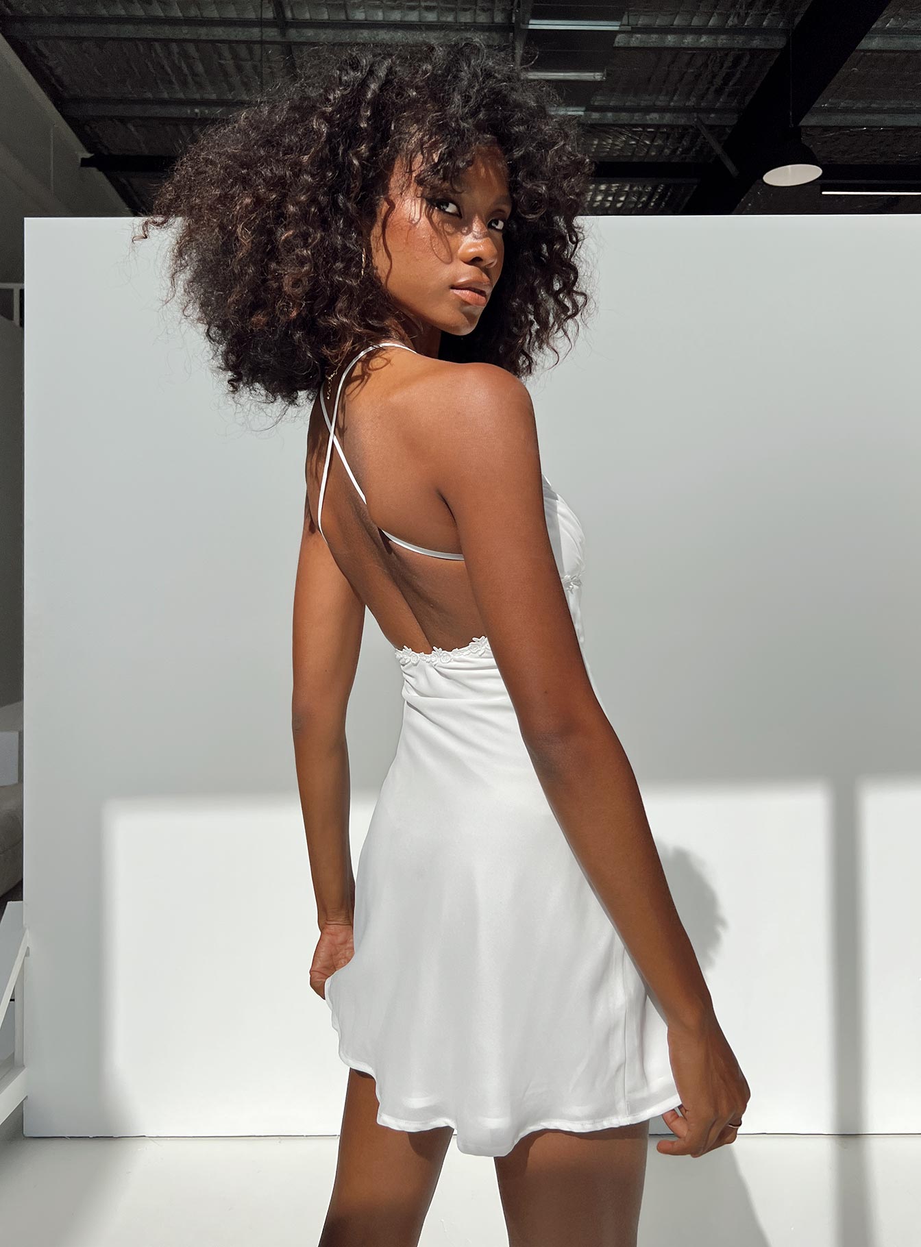 White mini dress Adjustable shoulder straps V neckline Knitted lace detail Cross straps at back Invisible zip fastening at side