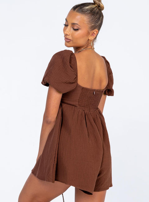 Romper Muslin material Square neckline  Elasticated puff sleeves Shirred back panel Invisible zip fastening at back  Relaxed leg 