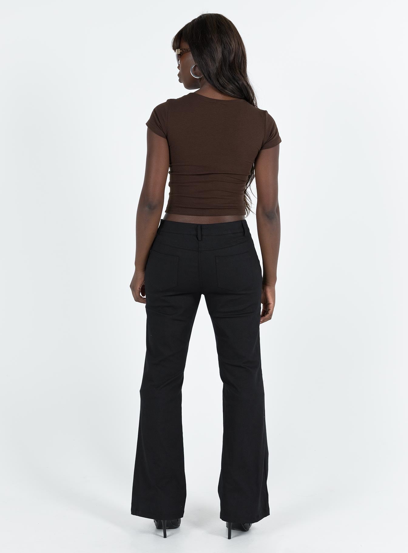 Black pants Low rise Belt looped waist Twin hip pockets Slim leg  Slightly flared cuff