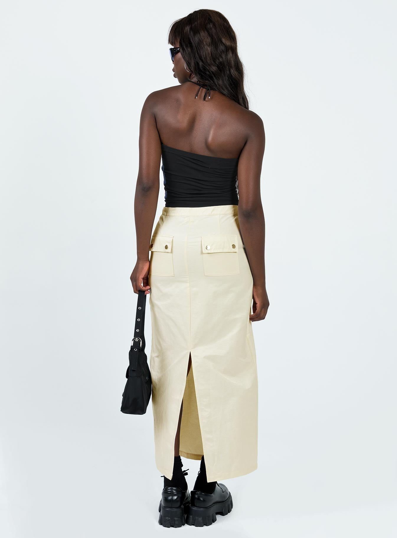 Maxi skirt Mid-low rise Invisible zip fastening at side Twin hip pockets Press button back pockets Drawstring at waist Slit at back