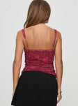 Red top V neckline, floral print, adjustable straps, ruching at sides