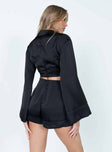 Black romper Silky material Classic collar  Plunging neckline  Semi-detached shorts  Gold-toned ring at waist  Flared long sleeves  Elasticated waistband  Fixed rolled hem  Separate invisible zips at back of top & shorts 