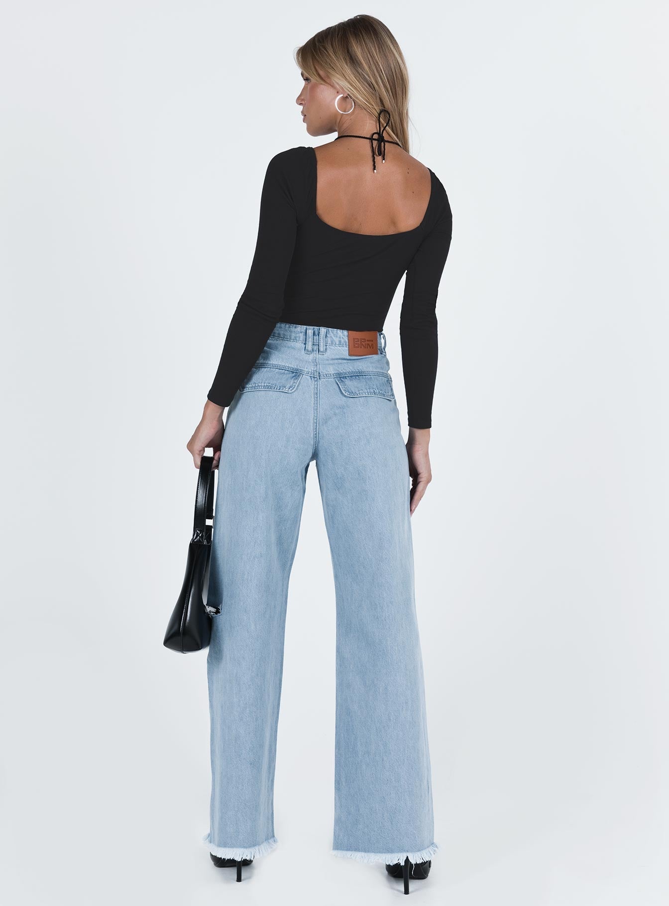 Wide leg jeans Mid wash denim Front button and zip fastening Belt looped waist Twin hip pockets Faux back pockets Ripped leg Frayed hem