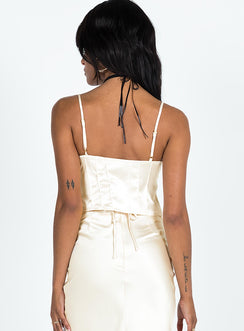 Cami top Silky material Adjustable shoulder straps Lace trim Scooped neckline Lace up fastening at bust Split hem