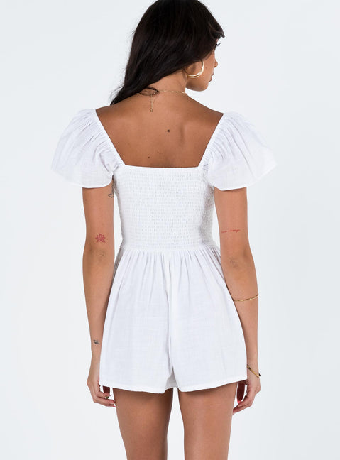 White romper Elasticated shoulders & neckline  Tie at bust  Shirred waist  Twin hip pockets  Fully lined 