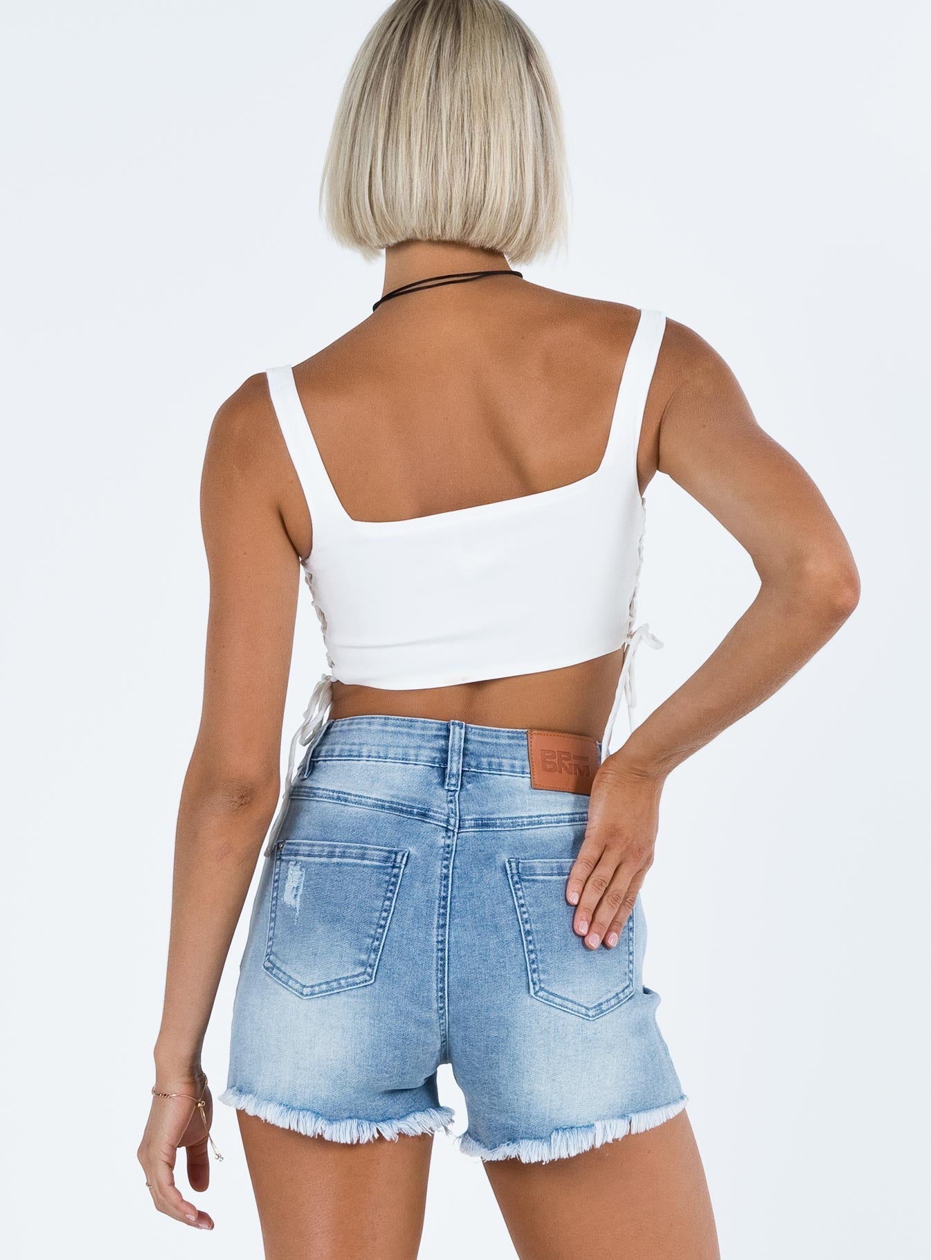Denim shorts High rise Mid-wash faded denim Belt looped waist Zip and button fastening Classic five pocket design Distressed detail and hem Branded patch at back