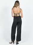 Jumpsuit Silky material Adjustable shoulder straps Lace up back Invisible zip fastening at back Wide leg