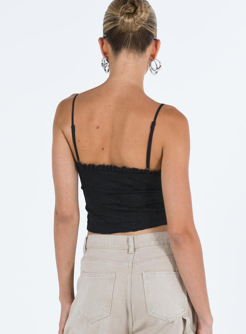 Crop top Lace material  Ruffle neckline  Adjustable shoulder straps  Inner silicone strip at bust  Lace up fastening at front Non stretch Fully lined 