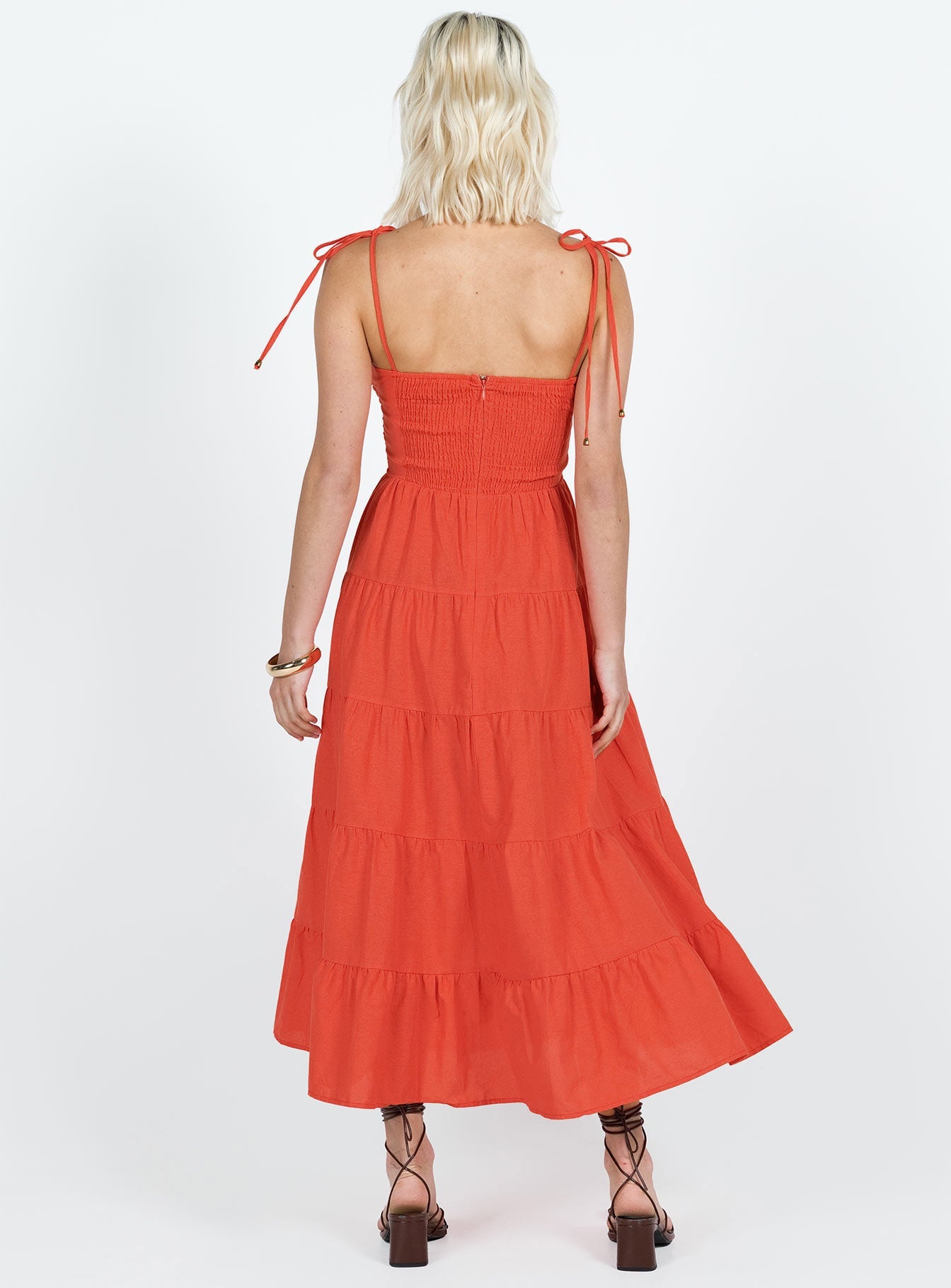 Midi dress Tie fastening shoulder straps Knot detail at bust Shirred band at back Cut out at waist Invisible zip fastening at back Tiered skirt