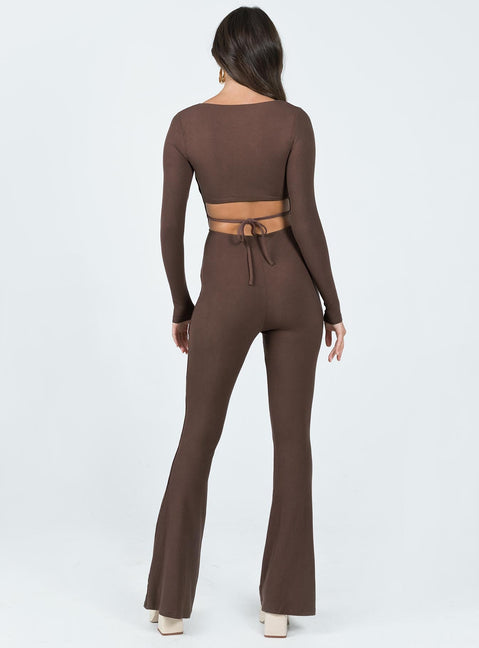 Long sleeve jumpsuit Ribbed material Square neckline Cut out at back with tie fastening Good stretch Partially lined