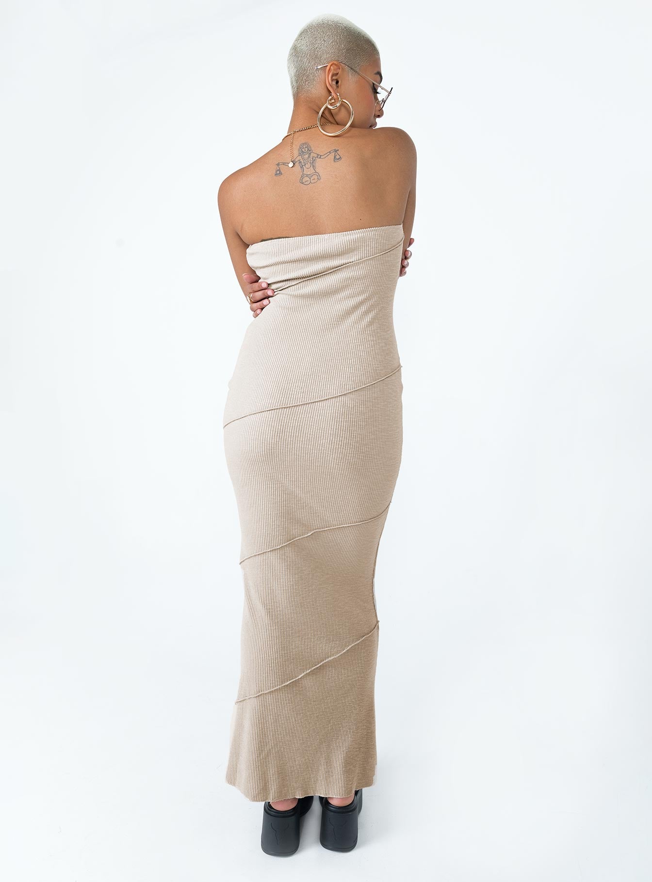 Strapless midi dress Soft knit material Diagonal stitching Inner silicone strip at bust Invisible zip fastening at side Good stretch