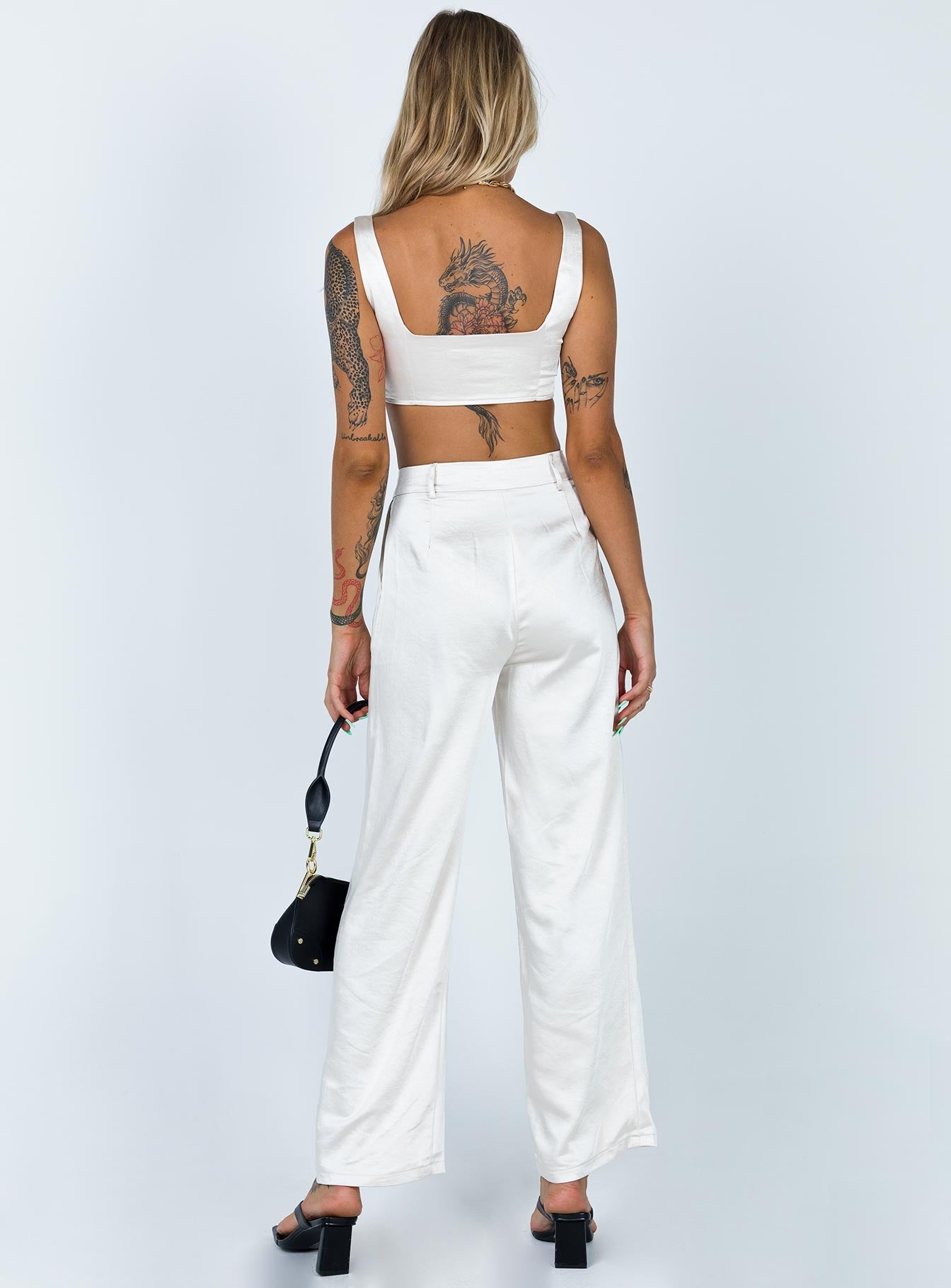 Matching set Soft silky material Crop top Fixed straps Invisible zip fasting at side High waisted pants Wide relaxed leg Belt loops at waist Zip & button fastening Lined top