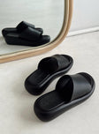 Black sandals Faux leather material Single wide upper Padded footbed Platform base