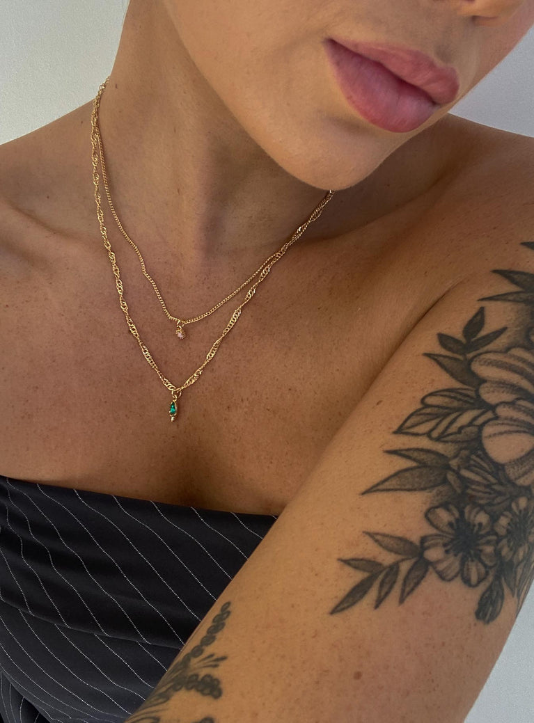Necklace pack 90% recycled steel 5% recycled zinc 5% glass Pack of two  Fixed design - these can not be worn separately  Dainty gold chains  Small pendants  Lobster clasp fastening 