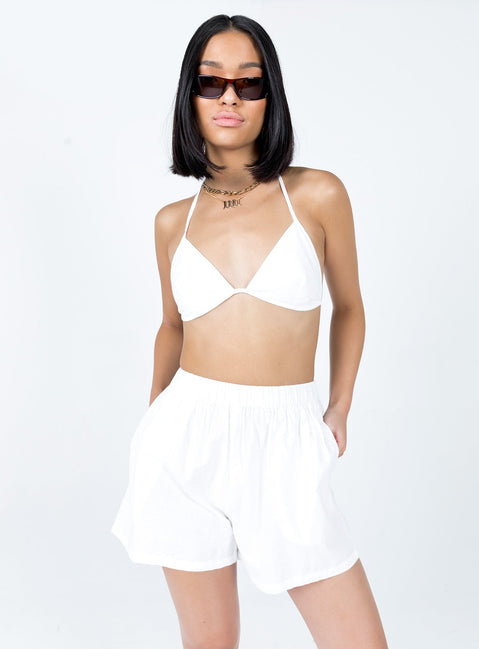 Matching three-piece set Bra top  Halter neck tie fastening  Oversized vest top  Lapel collar  Button front fastening  Twin front pockets  High waisted shorts  Elasticated waistband  Twin hip pockets 