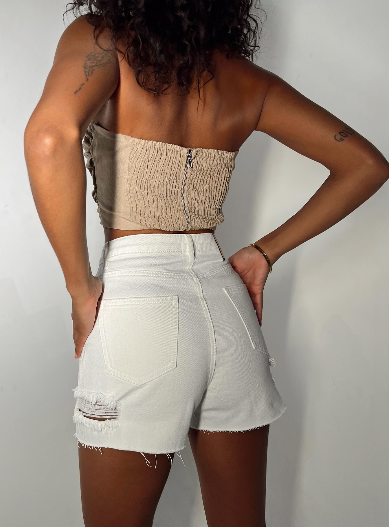 Denim shorts High waisted Belt looped waist Classic five pocket design Button & zip fastening Distressed detail on leg Raw cut hem 