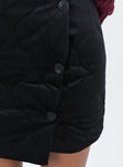 Black mini skirt Quilted material High rise Invisible zip fastening at back Button detail at front