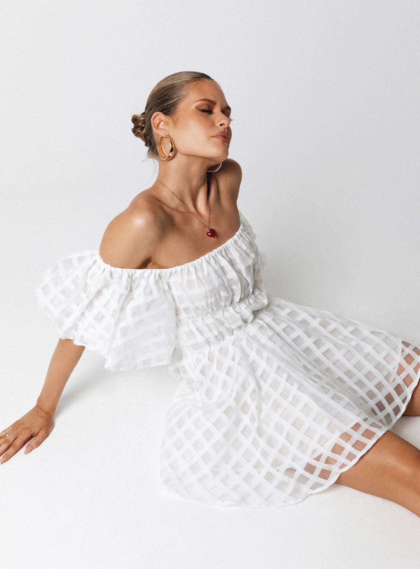 White mini dress Sheer material Off the shoulder design Puff sleeve Elasticated bands at waist