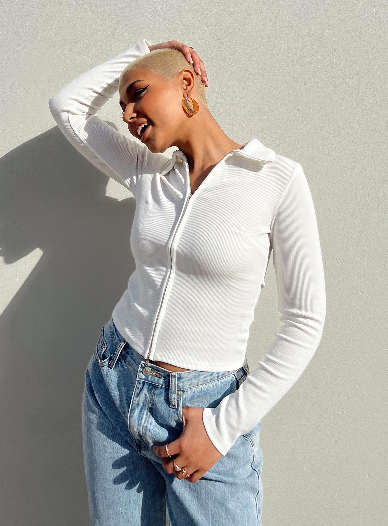 White long sleeve top Ribbed material  Classic collar  Double ended zip fastening 