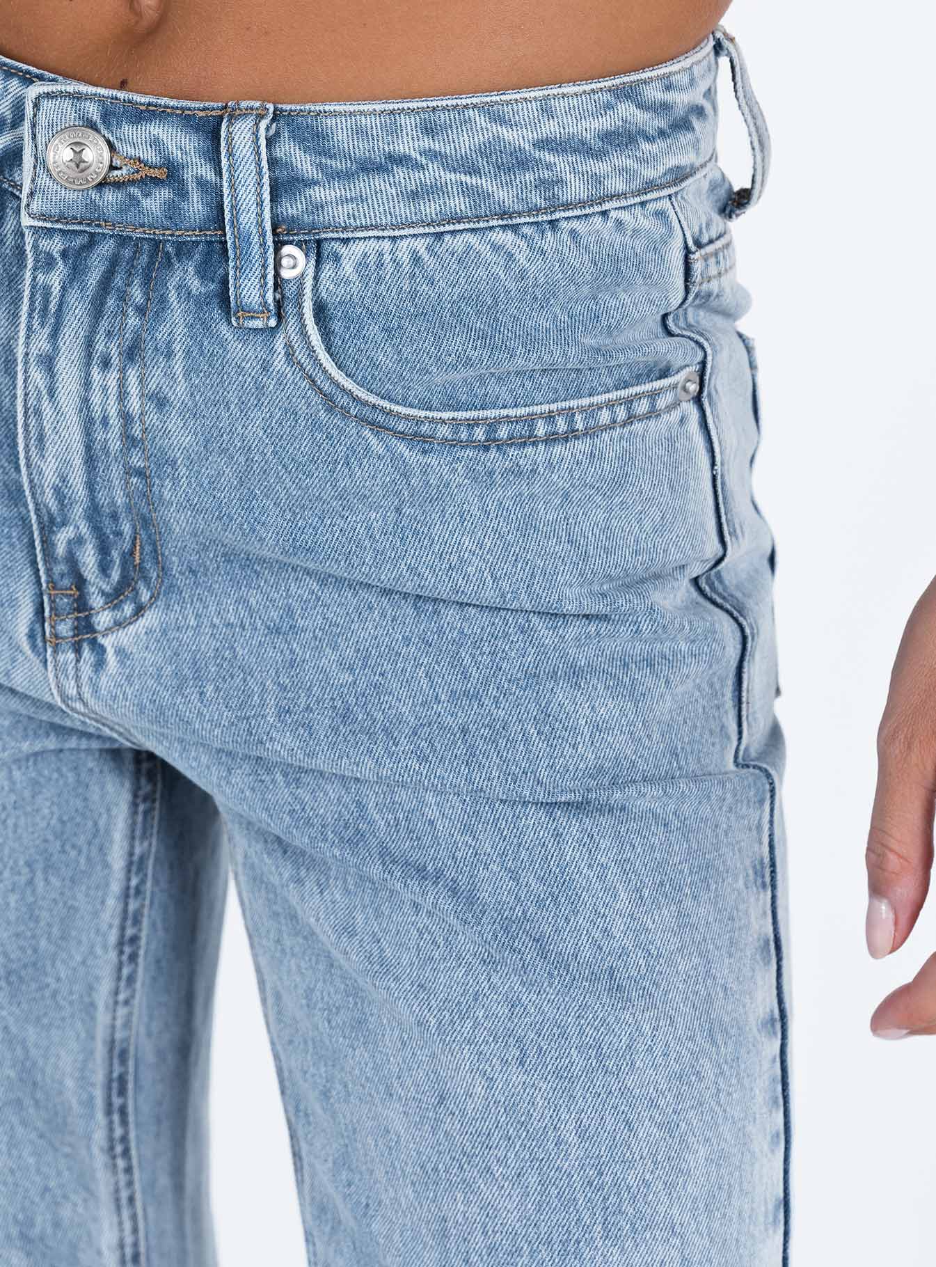 Jeans Mid wash denim Low rise Belt looped waist Classic five pocket design Branded patch at back Slim leg Split at hem Raw edge hem