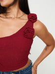 Red One shoulder top Lace material, flower detail on shoulder, ruching at sides, asymmetric hem